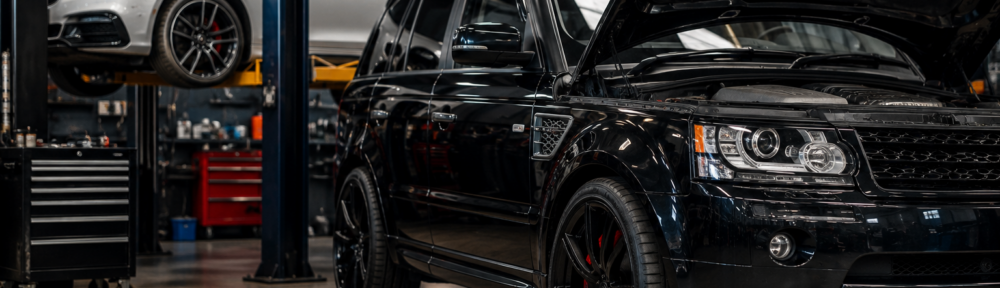 Black Range Rover with bonnet open in a workshop, being inspected for air suspension problems in Mandurah