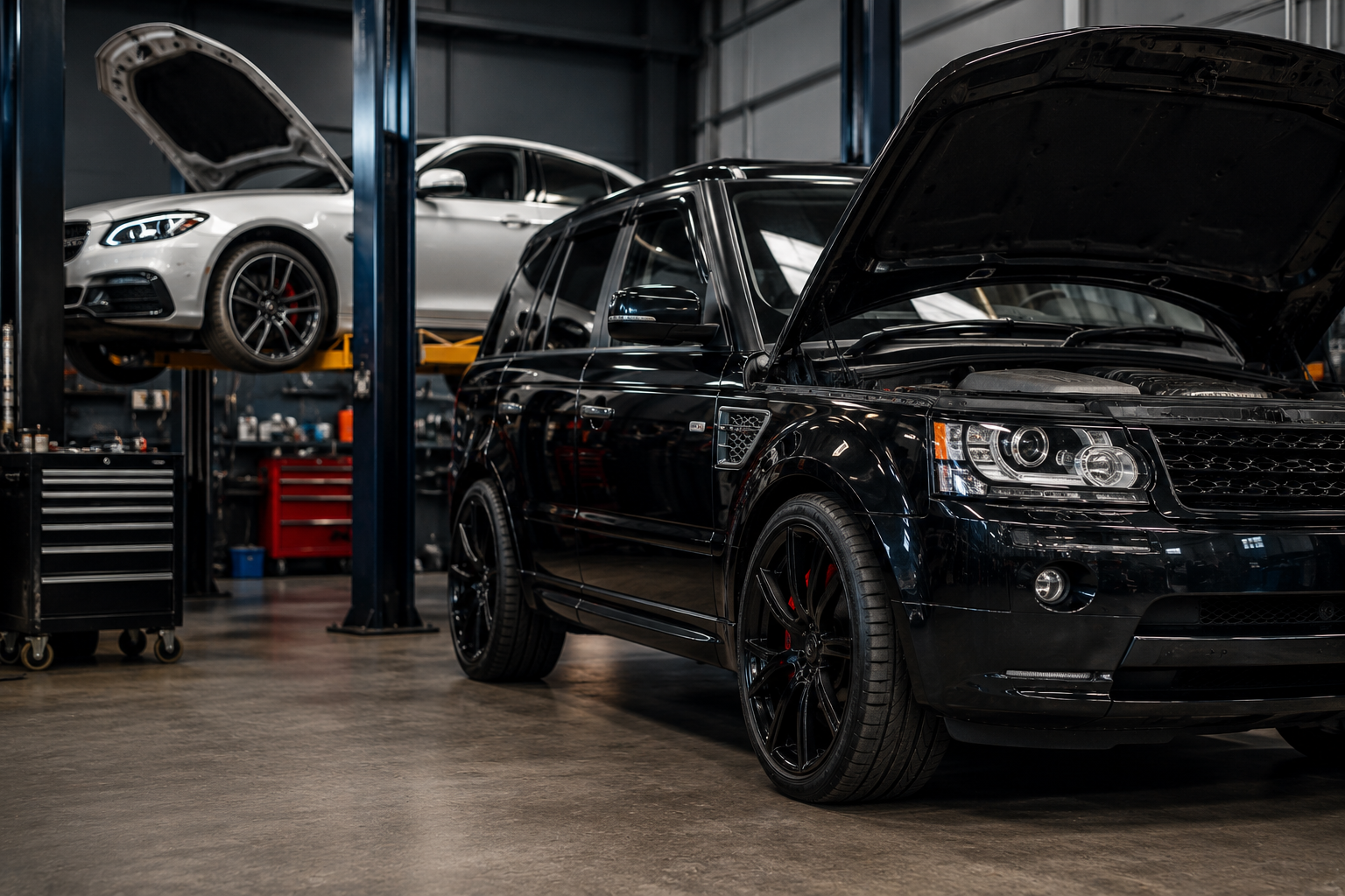 Black Range Rover with bonnet open in a workshop, being inspected for air suspension problems in Mandurah